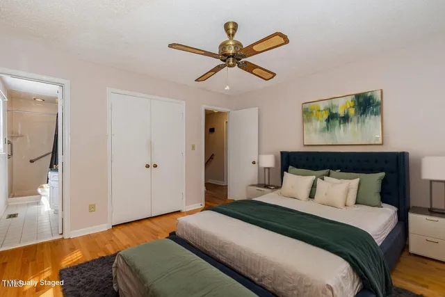 a view of a room with wooden floor and ceiling fan