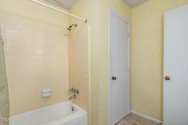a bathroom with a granite countertop toilet sink and mirror