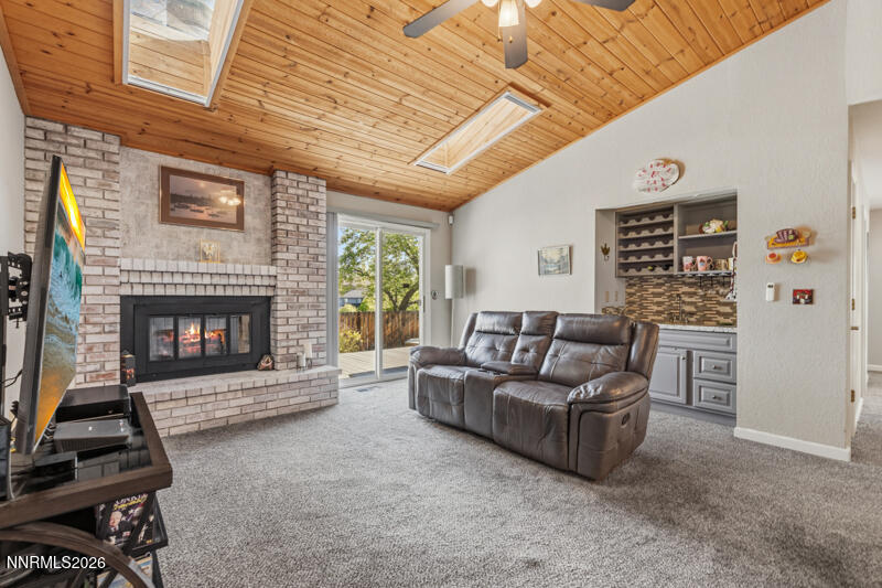675 College Drive Reno, NV 89503 - Photo 13 of 30 a living room with furniture a fireplace and a flat screen tv