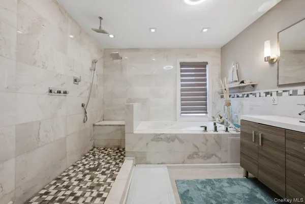 a bathroom with a double vanity sink toilet and shower