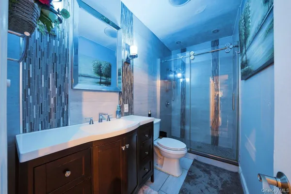 a bathroom with a double vanity sink toilet and shower