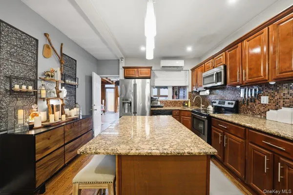 a kitchen with stainless steel appliances granite countertop a sink a stove and cabinets