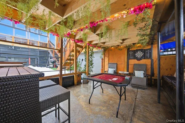 a living room with furniture a couch and a potted plant