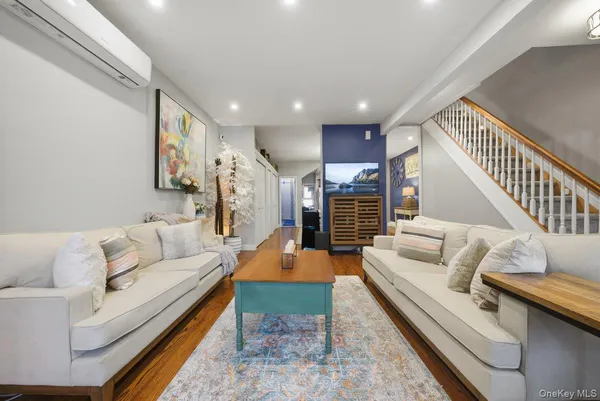 a view of entryway and hall with wooden floor