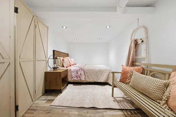 a bedroom with a white bed and white walls