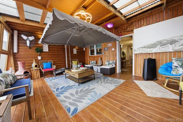 a view of a patio with a table and chairs under an umbrella