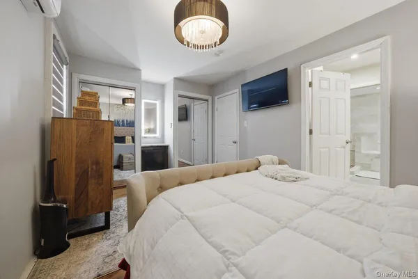 a bedroom with a bed and a flat tv screen