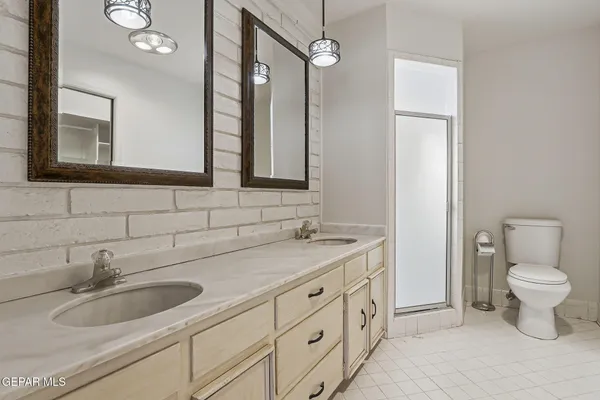 a large kitchen with stainless steel appliances lots of counter space and wooden floor