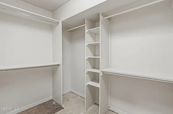 a kitchen with granite countertop stainless steel appliances a stove refrigerator and microwave