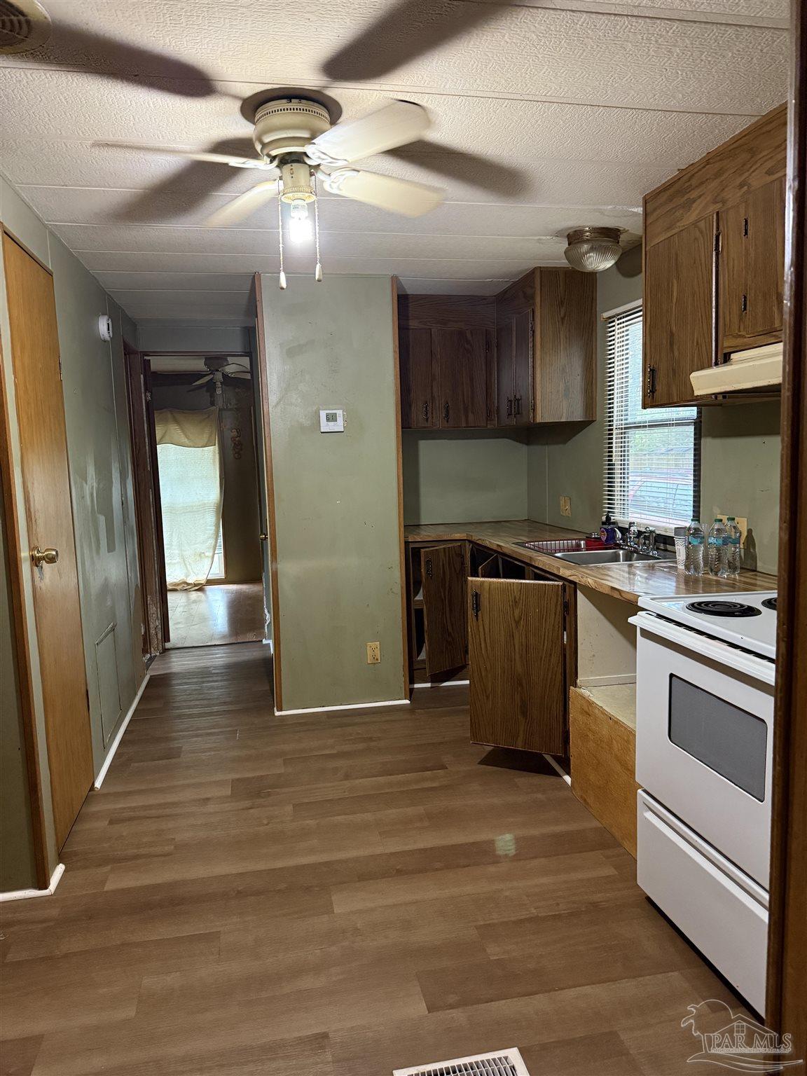 2866 Pine Forest Road, Unit 5 Cantonment, FL 32533 - Photo 6 of 10 a kitchen with stainless steel appliances granite countertop a sink a stove and a refrigerator