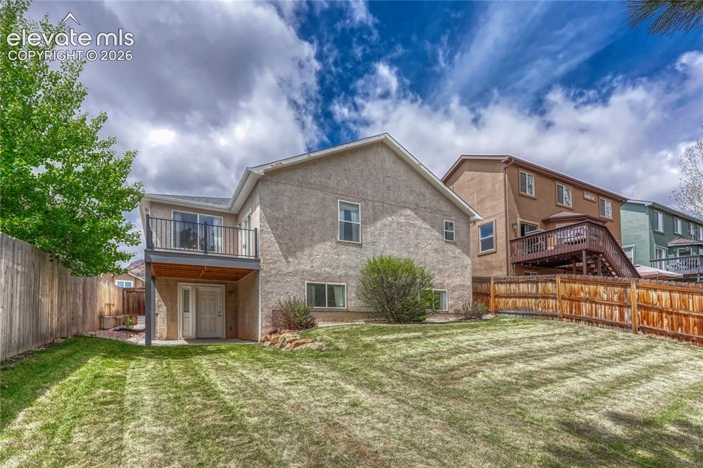 7285 Julynn Road Colorado Springs, CO 80919 - Photo 42 of 45 a front view of a house with garden