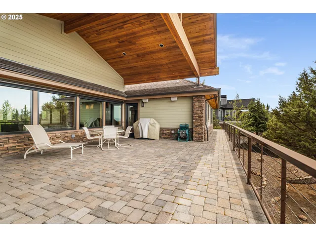 a view of a patio with a table and chairs
