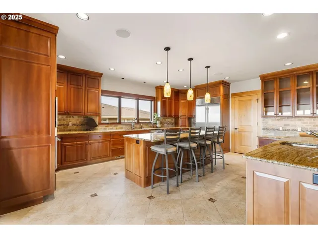a kitchen with lots of counter top space and stainless steel appliances