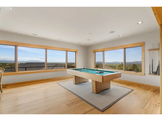 a living room with a large window and a table