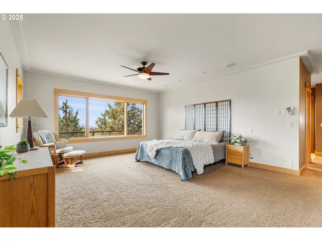 a spacious bedroom with a large bed and a large window