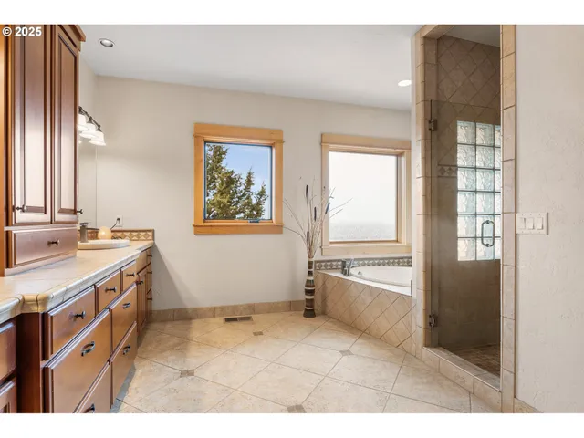 a bathroom with a granite countertop sink a toilet and bathtub
