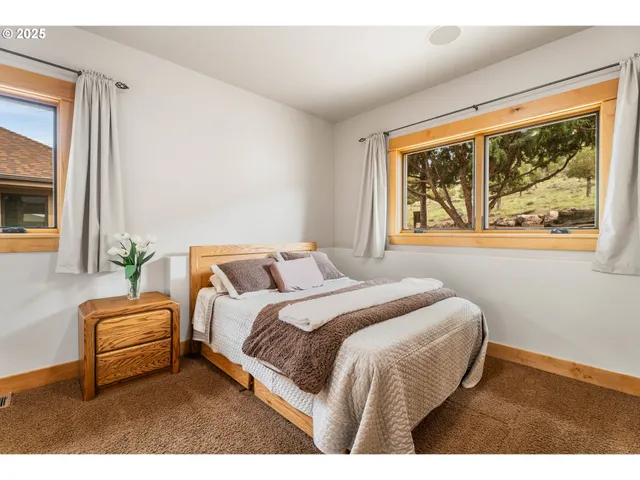 a bedroom with a bed lamp and window