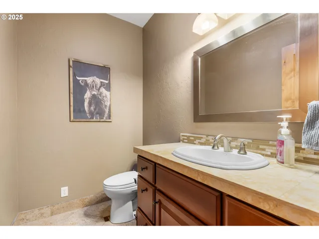 a bathroom with a toilet a sink and mirror