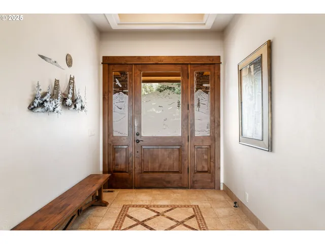a view of a hallway with wooden floor and a living room