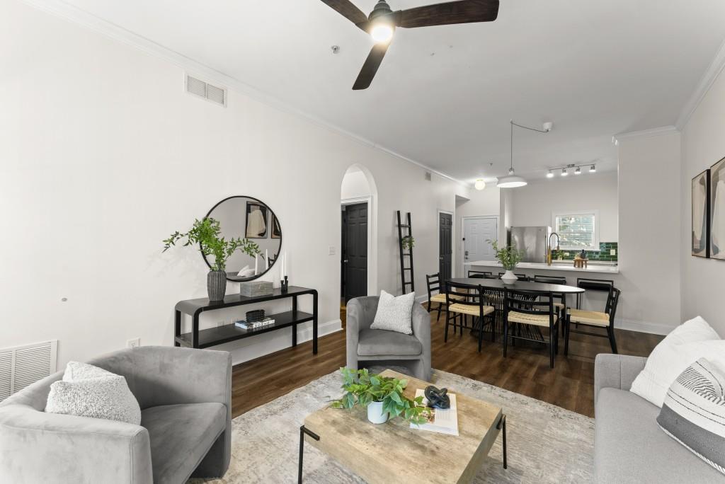1635 Briarcliff Road Northeast, Unit 8 Atlanta, GA 30306 - Photo 11 of 25 a living room with furniture a rug and a chandelier