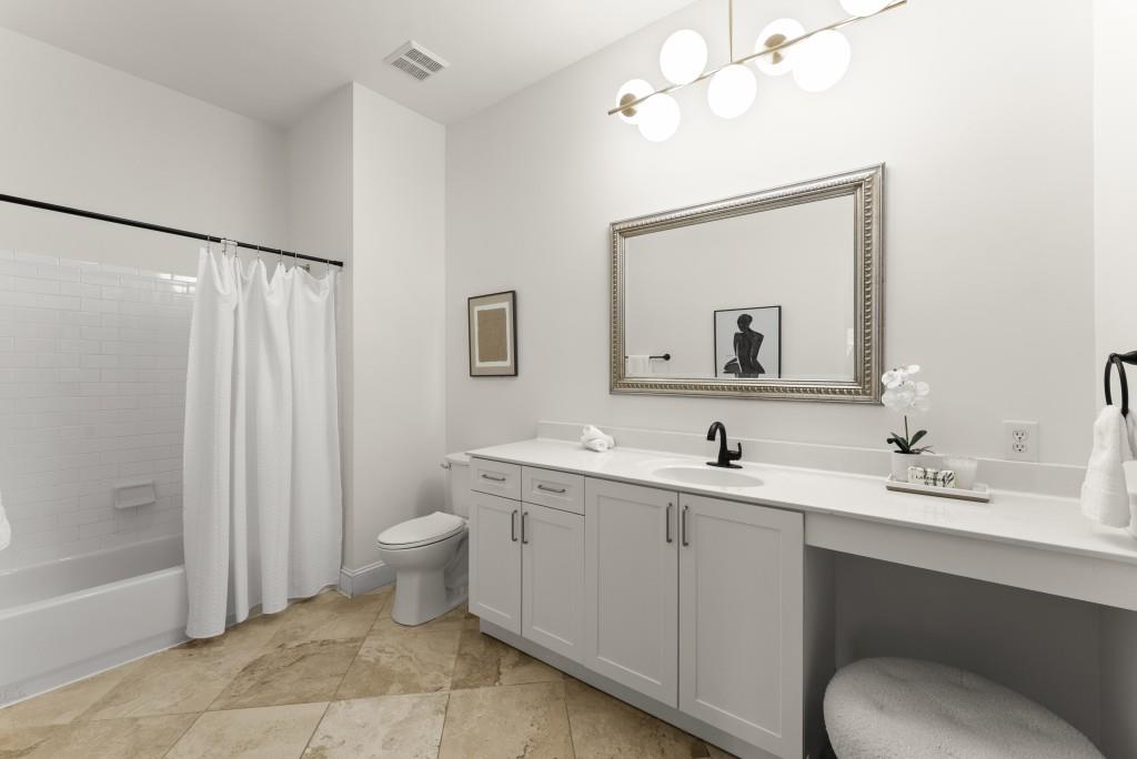 1635 Briarcliff Road Northeast, Unit 8 Atlanta, GA 30306 - Photo 16 of 25 a bathroom with a toilet sink and mirror