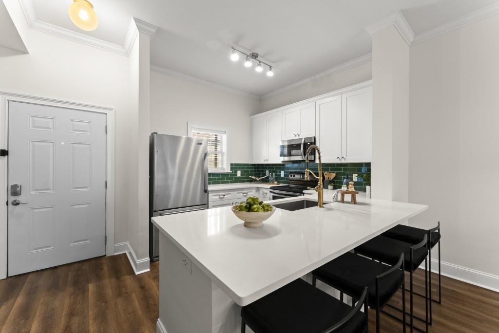 1635 Briarcliff Road Northeast, Unit 8 Atlanta, GA 30306 - Photo 3 of 25 a kitchen with a sink a stove and refrigerator