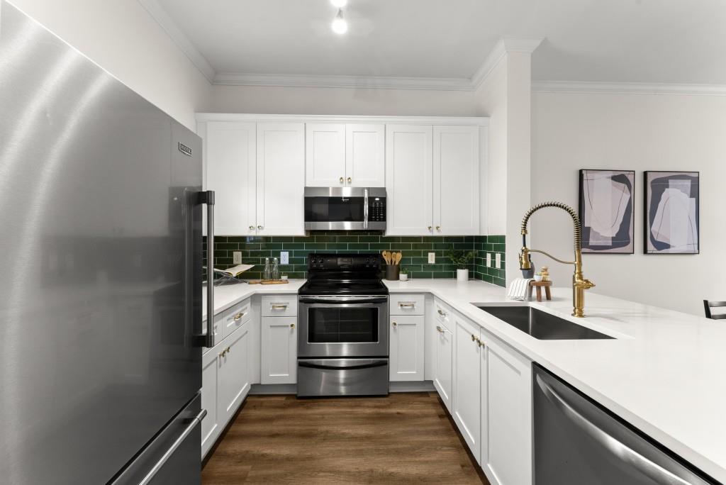 1635 Briarcliff Road Northeast, Unit 8 Atlanta, GA 30306 - Photo 6 of 25 a kitchen with granite countertop white cabinets and stainless steel appliances
