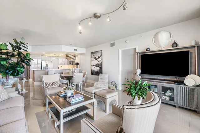 a view of a balcony with chair and a potted plant next to a window