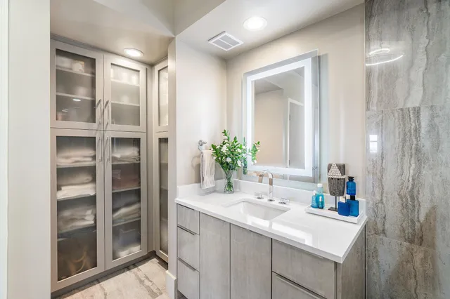 a bathroom with a sink a toilet and mirror