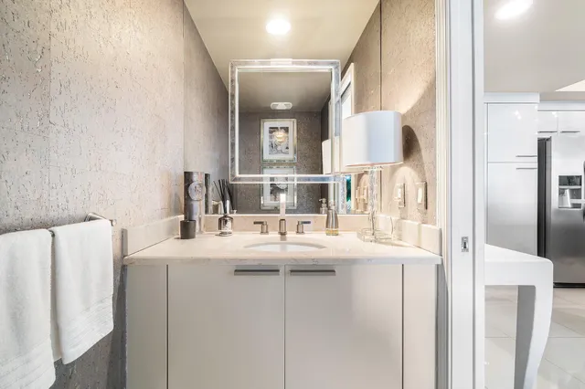 a view of a patio with a table and chairs under an umbrella