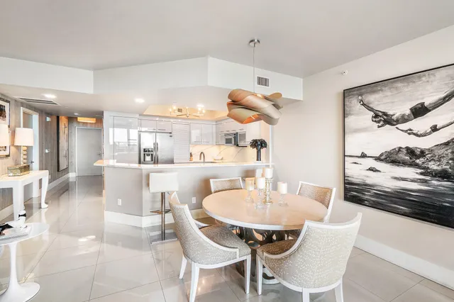 a dining room with furniture potted plants and wooden floor