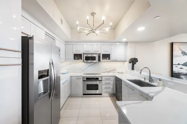 a kitchen with stainless steel appliances a refrigerator sink and cabinets