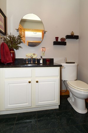 201 Andover Street Georgetown, MA 01833 - Photo 16 of 30 a bathroom with a toilet a sink and mirror
