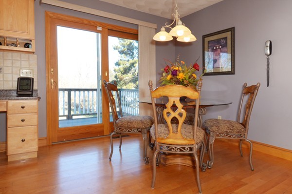 201 Andover Street Georgetown, MA 01833 - Photo 8 of 30 a dining room with furniture a chandelier and wooden floor