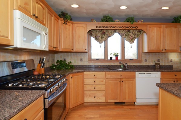 201 Andover Street Georgetown, MA 01833 - Photo 10 of 30 a kitchen with granite countertop a sink a stove and cabinets