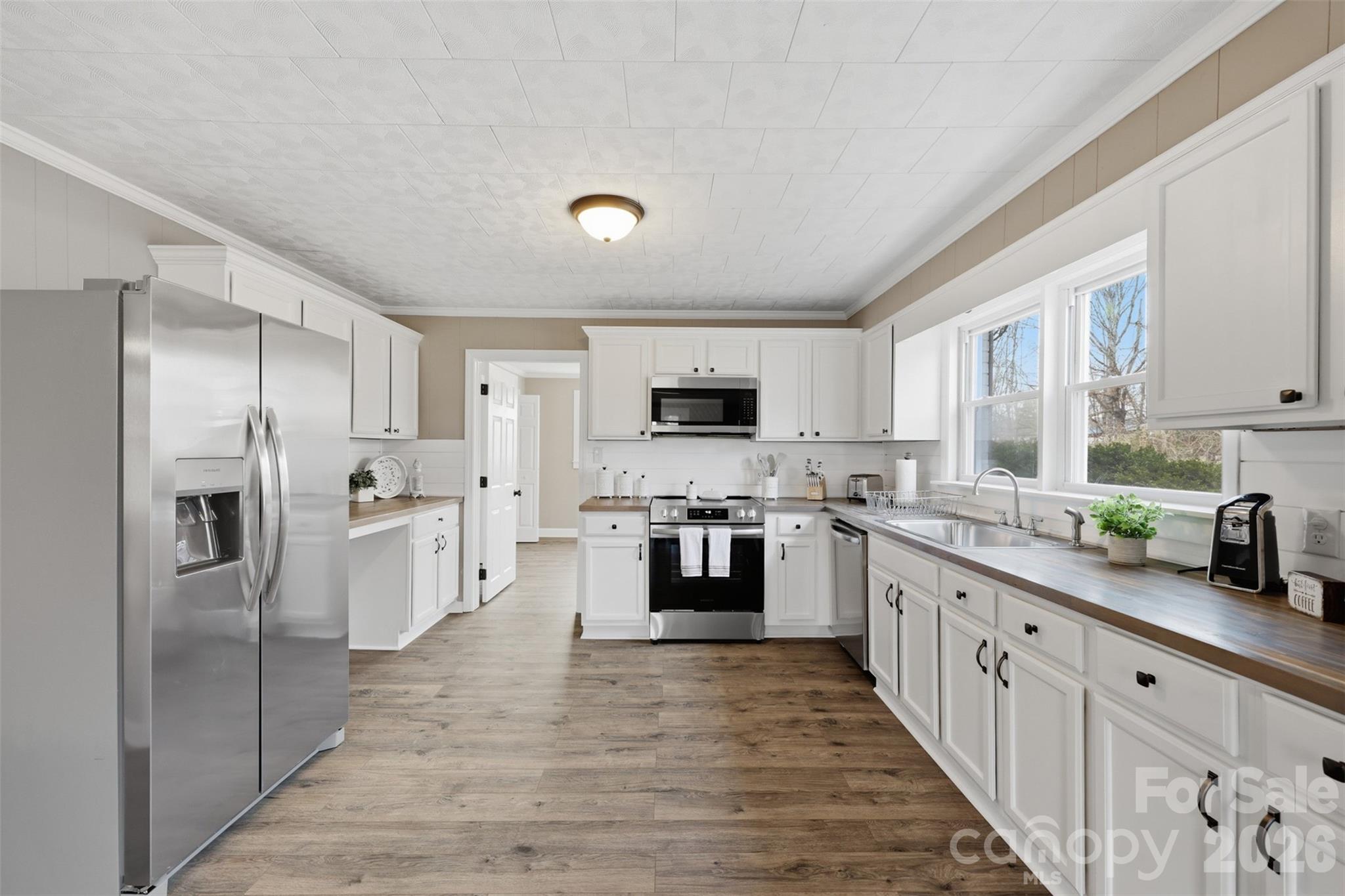 100 Boston Road Taylorsville, NC 28681 - Photo 11 of 41 a large kitchen with cabinets stainless steel appliances and a window
