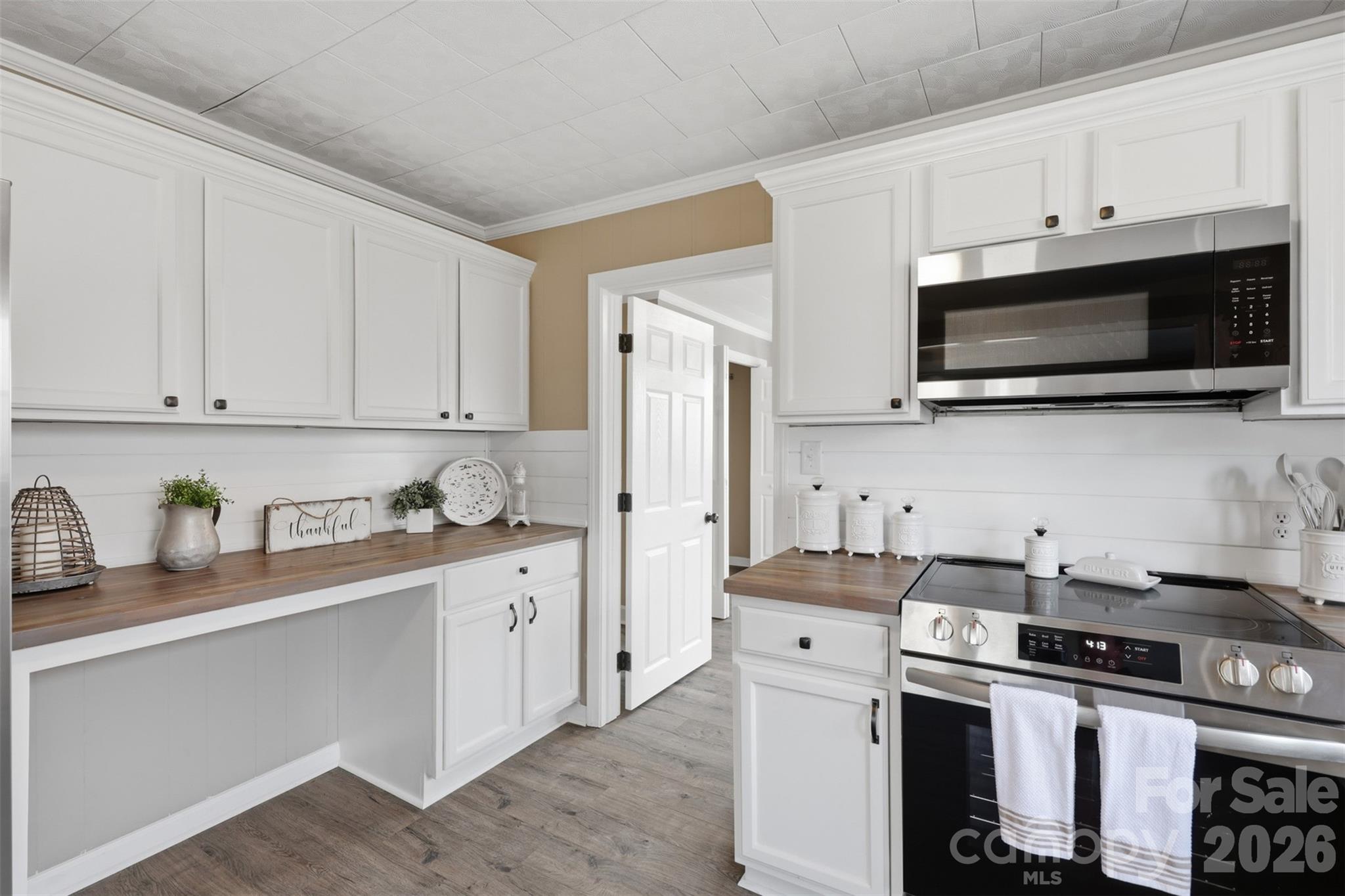 100 Boston Road Taylorsville, NC 28681 - Photo 12 of 41 a kitchen with stainless steel appliances granite countertop a stove a sink dishwasher and a refrigerator with wooden cabinets