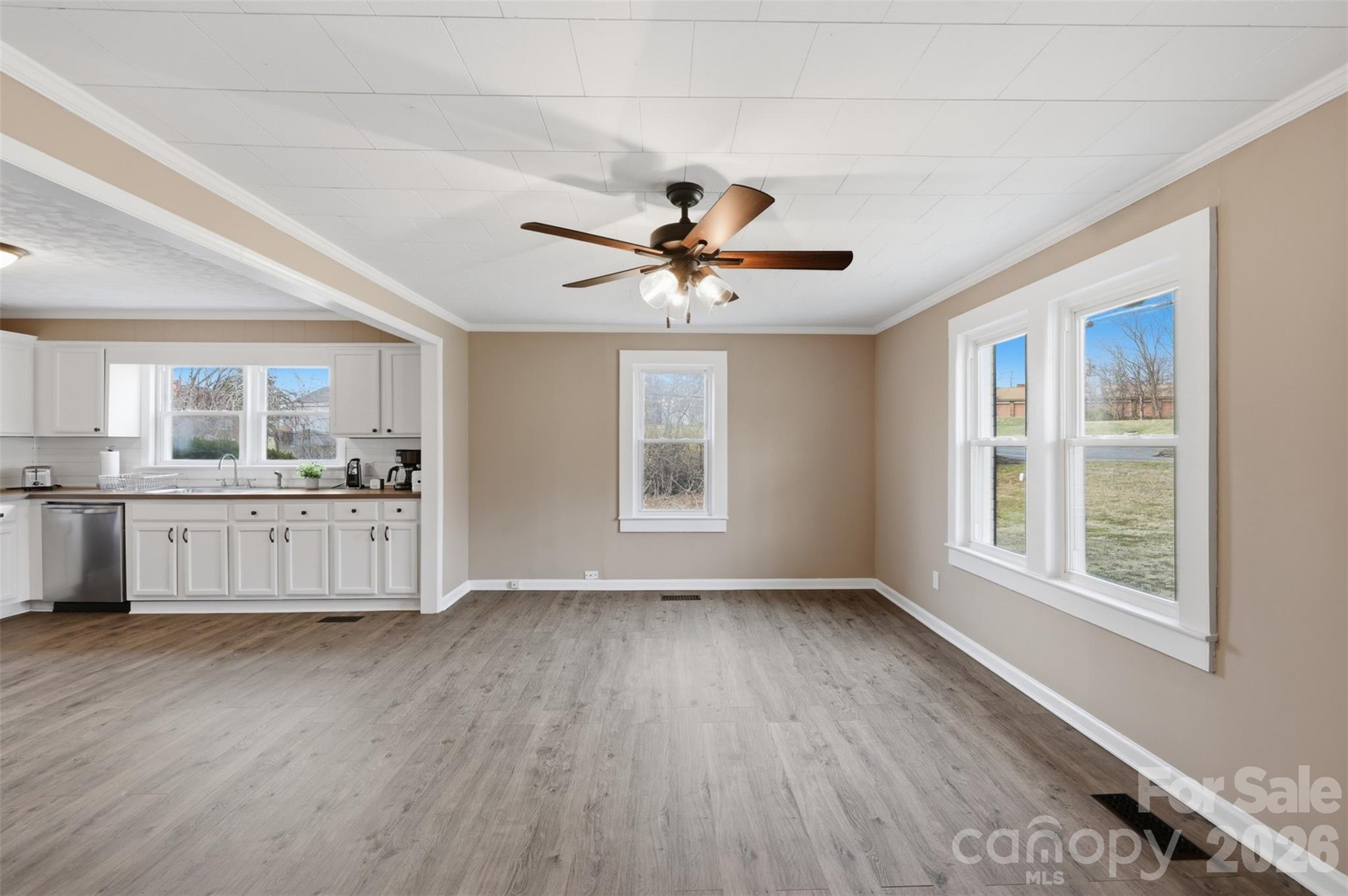 100 Boston Road Taylorsville, NC 28681 - Photo 15 of 41 a view of an empty room with a kitchen and wooden floor
