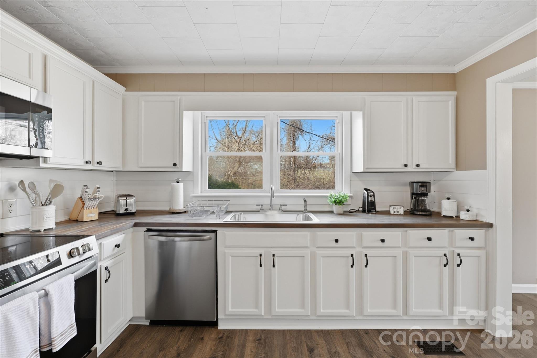 100 Boston Road Taylorsville, NC 28681 - Photo 9 of 41 a kitchen with granite countertop white cabinets and white appliances