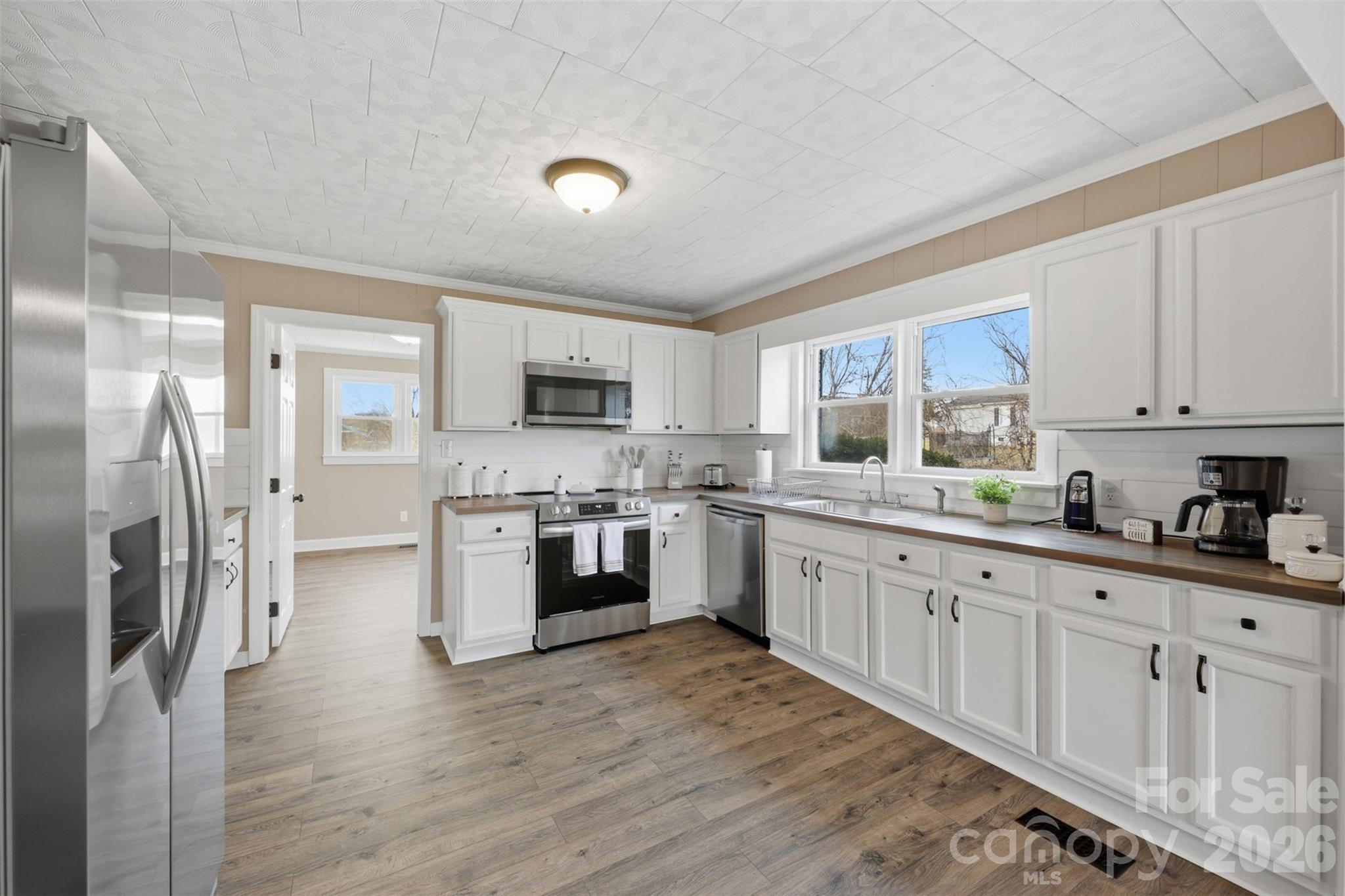 100 Boston Road Taylorsville, NC 28681 - Photo 10 of 41 a kitchen with granite countertop a refrigerator sink and wooden cabinets