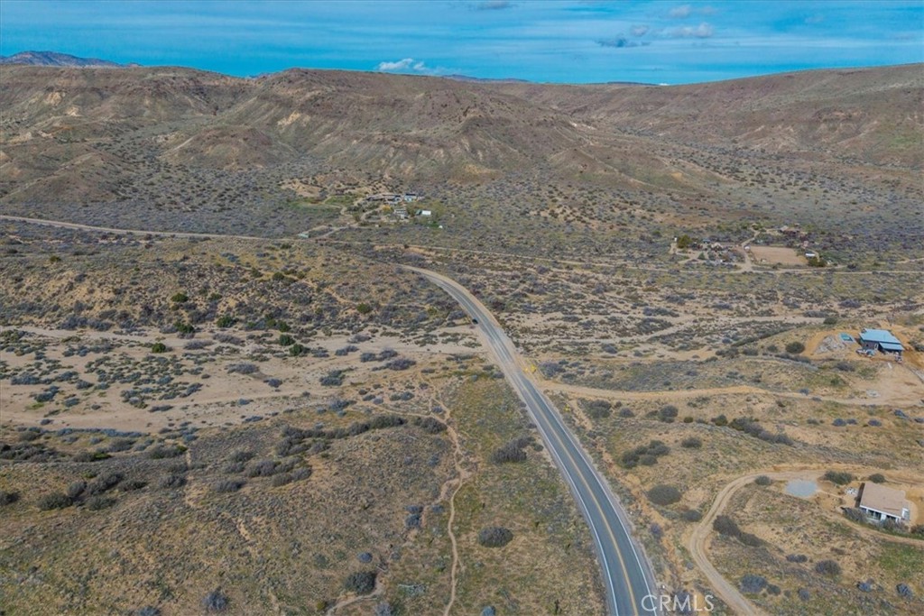 5190 Pioneertown Road Pioneertown, CA 92268 - Photo 12 of 30 a view of a dry yard with wooden floor and fence