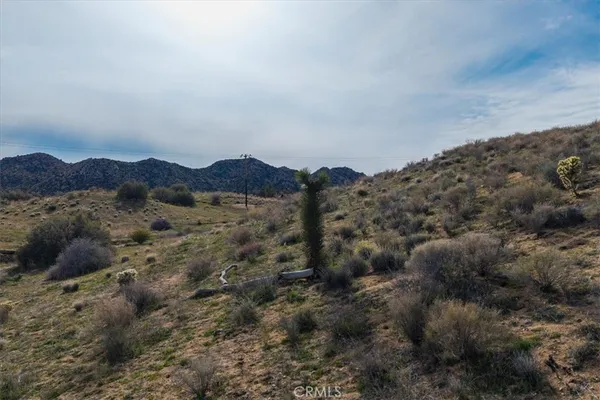 a view of a large mountain with mountains in the background