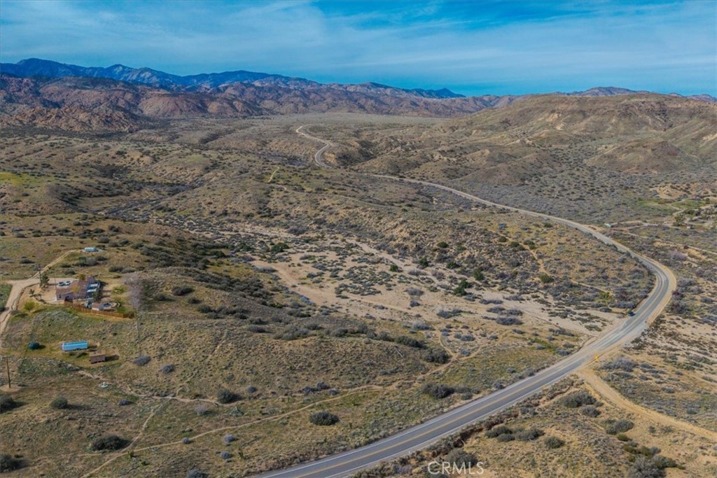 5190 Pioneertown Road Pioneertown, CA 92268 - Photo 23 of 30 a view of a dry yard with wooden floor and a ocean view