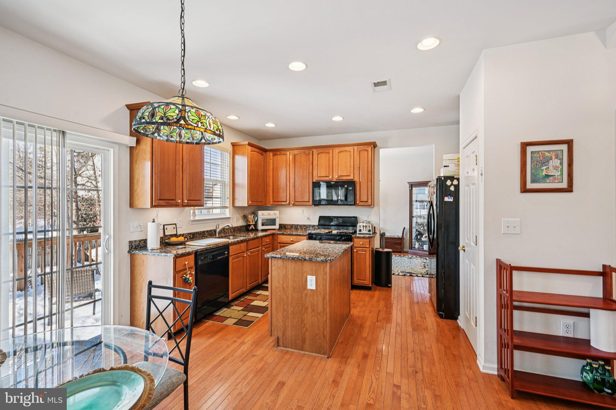 207 Waterford Road Egg Harbor Township, NJ 08234 - Photo 19 of 47 a kitchen with stainless steel appliances granite countertop a refrigerator a stove top oven a sink dishwasher and wooden cabinets with wooden floor