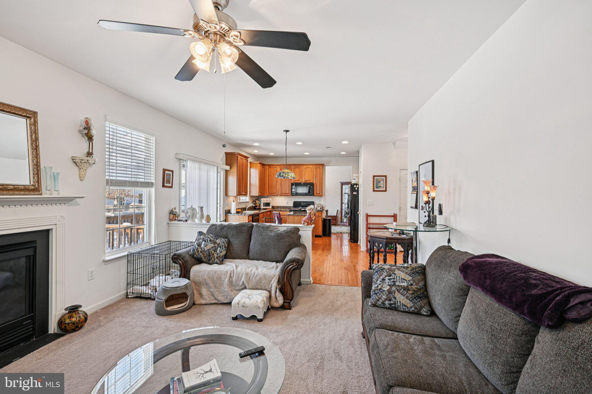 207 Waterford Road Egg Harbor Township, NJ 08234 - Photo 22 of 47 a living room with furniture kitchen view and a fireplace