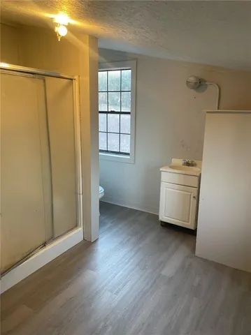 a view of a utility room with closet and wooden floor
