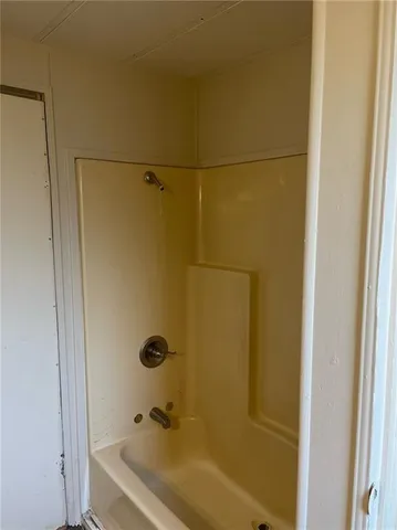 a bathroom with a tub and a shower