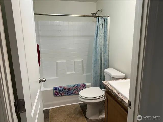 a bathroom with a toilet a sink and shower