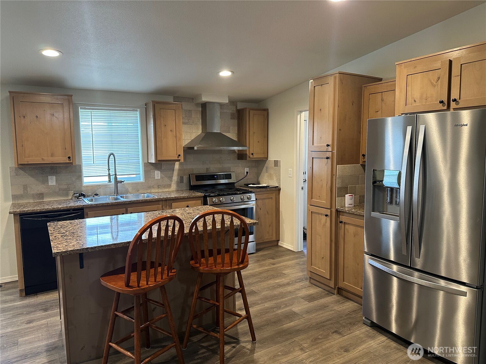 206 Mossyrock Road West Mossyrock, WA 98564 - Photo 4 of 24 a kitchen with stainless steel appliances granite countertop a refrigerator a stove a sink dishwasher and a refrigerator with wooden floor
