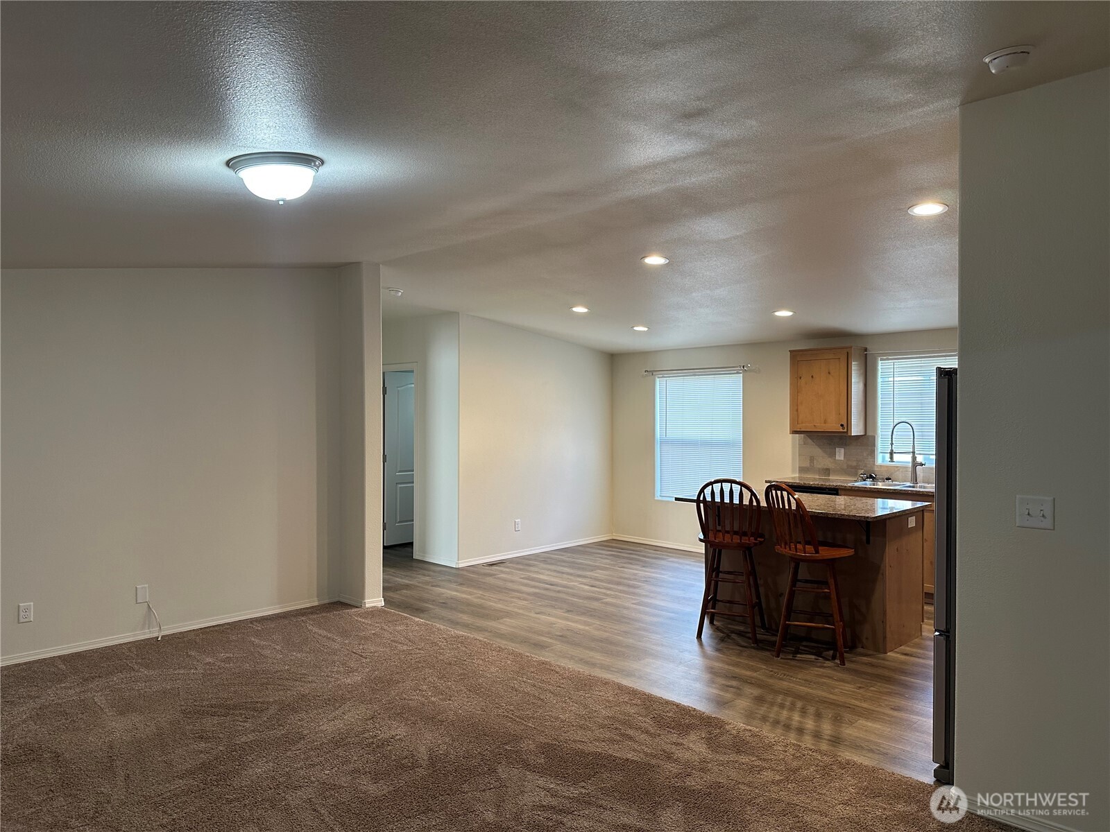 206 Mossyrock Road West Mossyrock, WA 98564 - Photo 5 of 24 an empty room with kitchen and chandelier